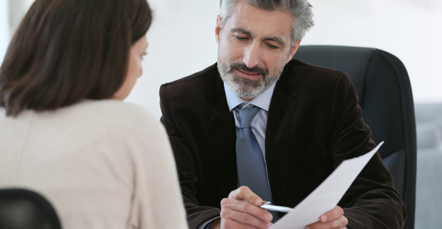 Man Looking at a Woman's Resume 